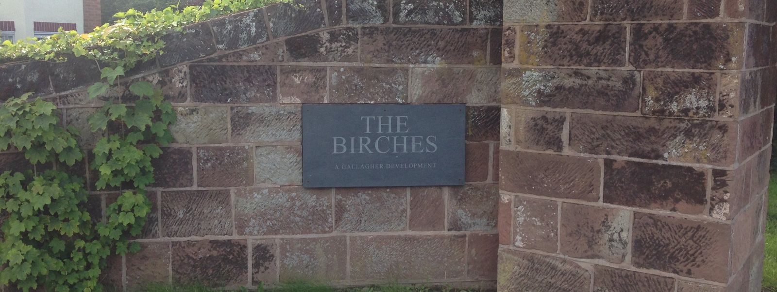 Completed sandstone entrance wall and sign at The Birches
